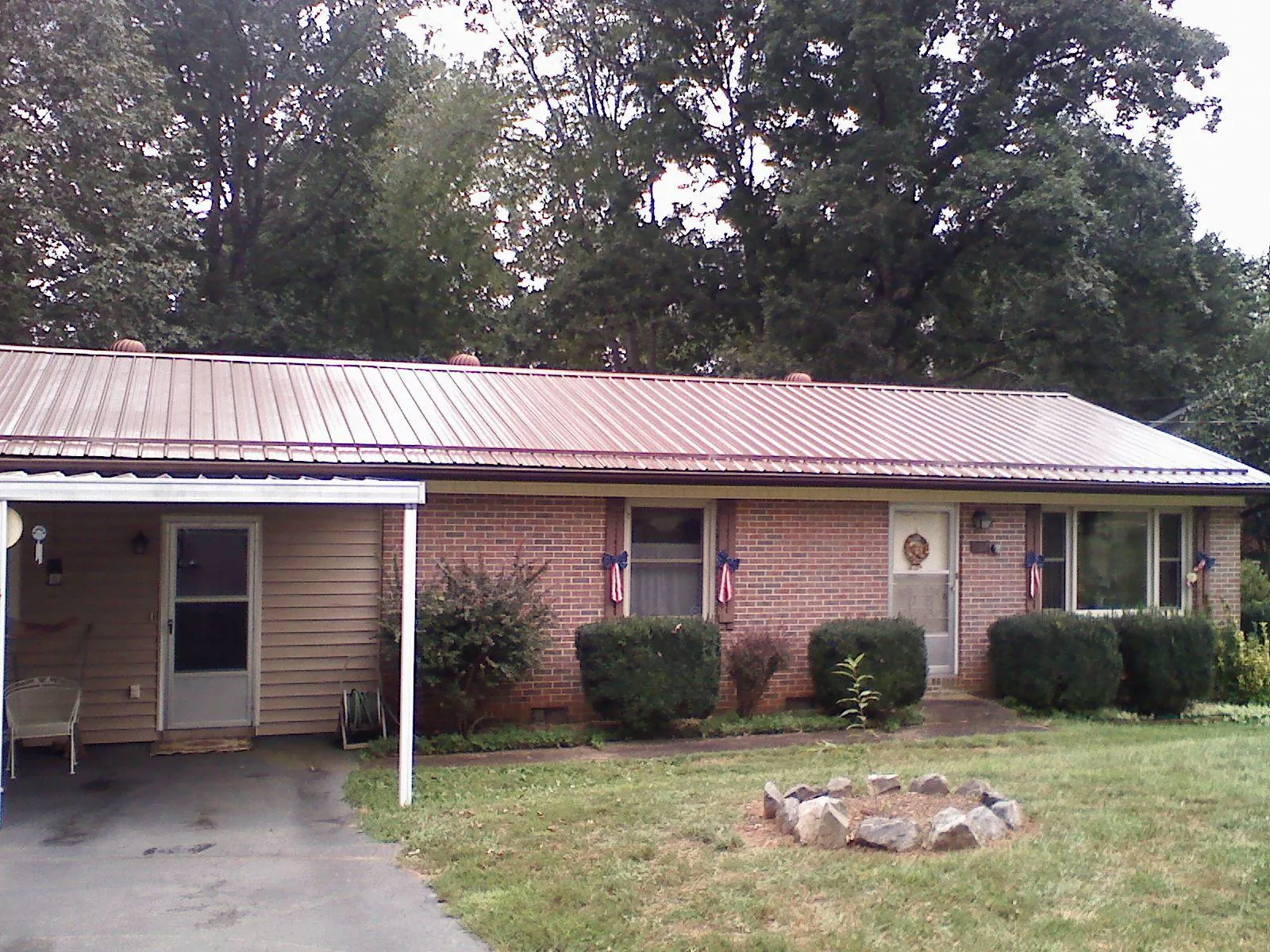 Bronze metal roof and carport on a brick ranch home — Roof Repair work by our crew in Lake Hiawatha